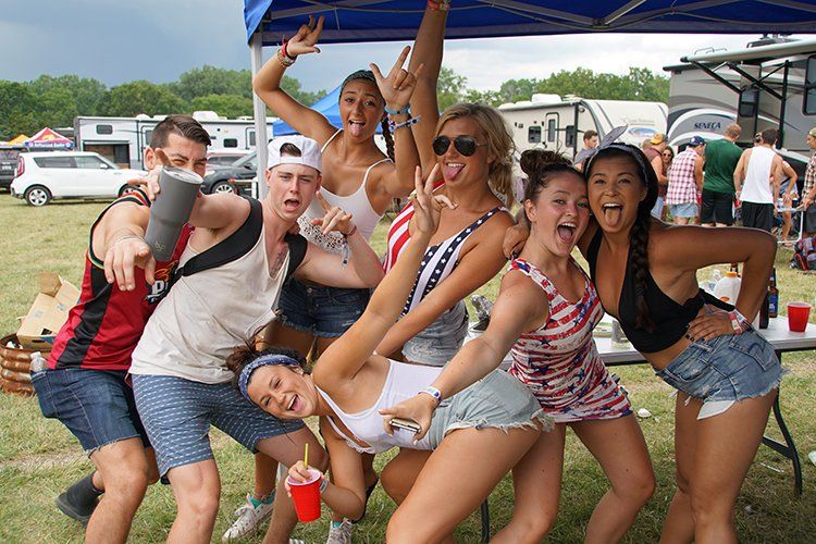 A group of people are posing for a picture under a tent.