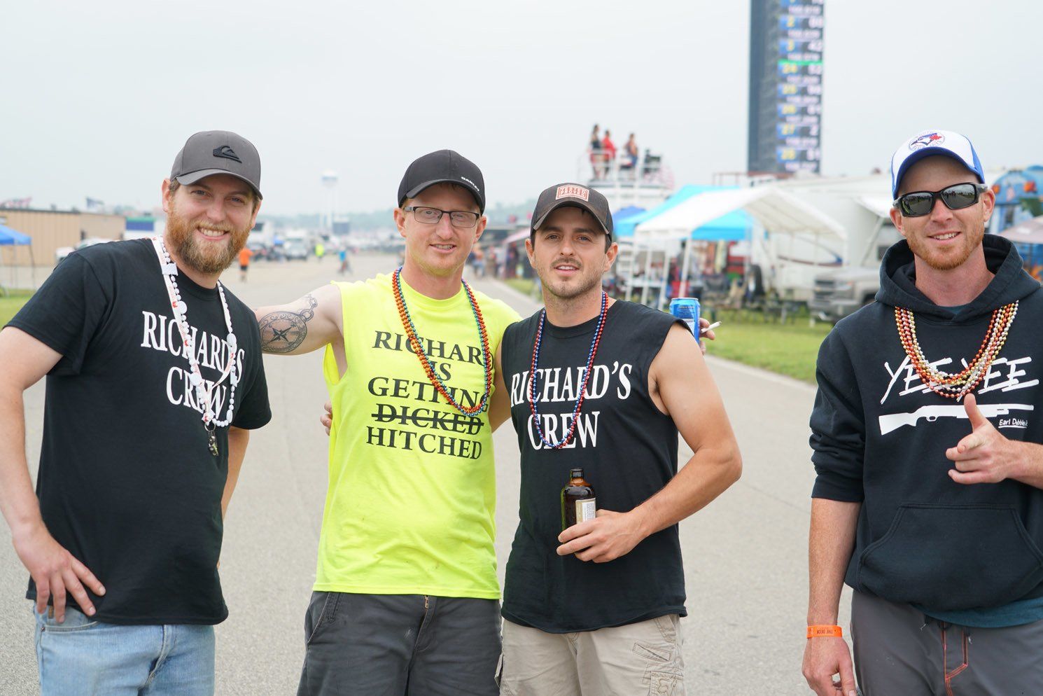 A group of men posing for a picture with one wearing a shirt that says richard 's crew