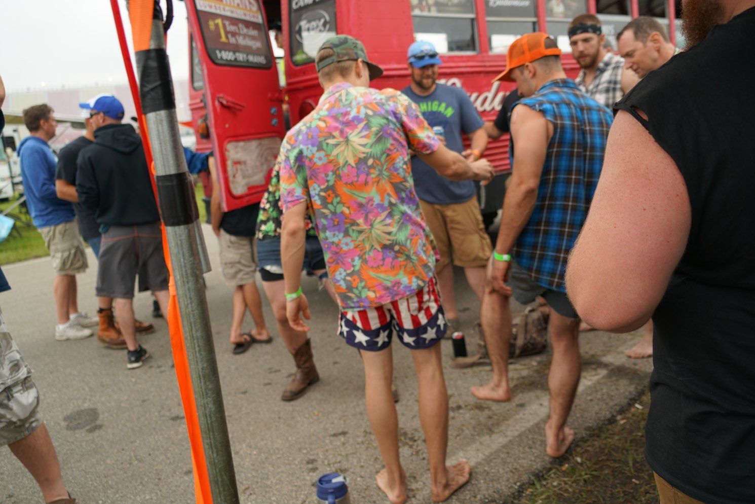 A group of men are standing in front of a food truck