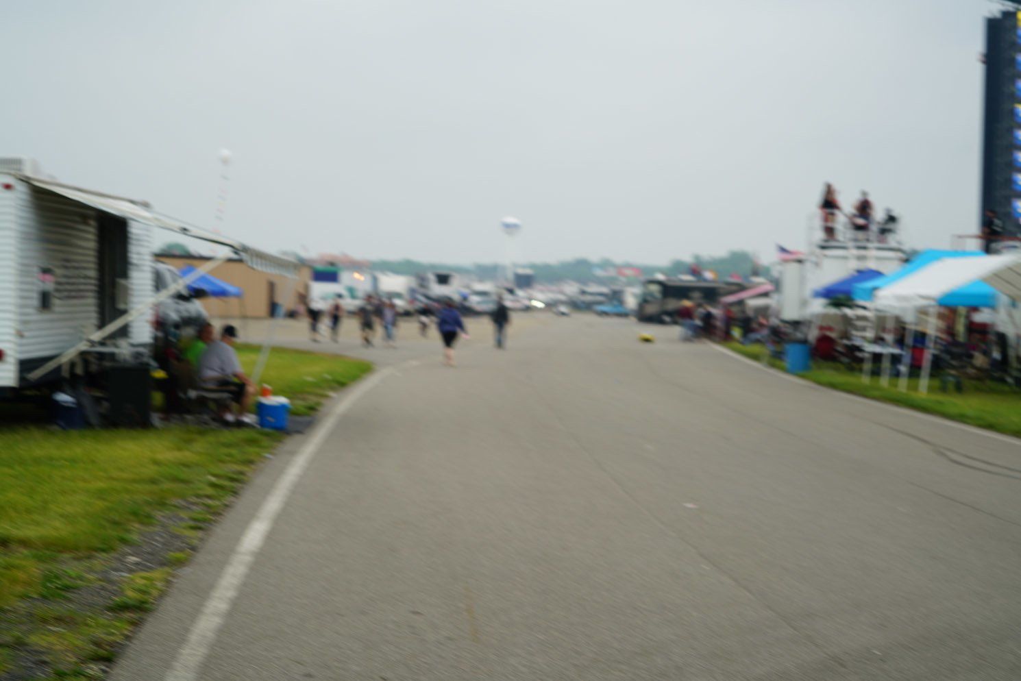 A blurred image of people walking down a road