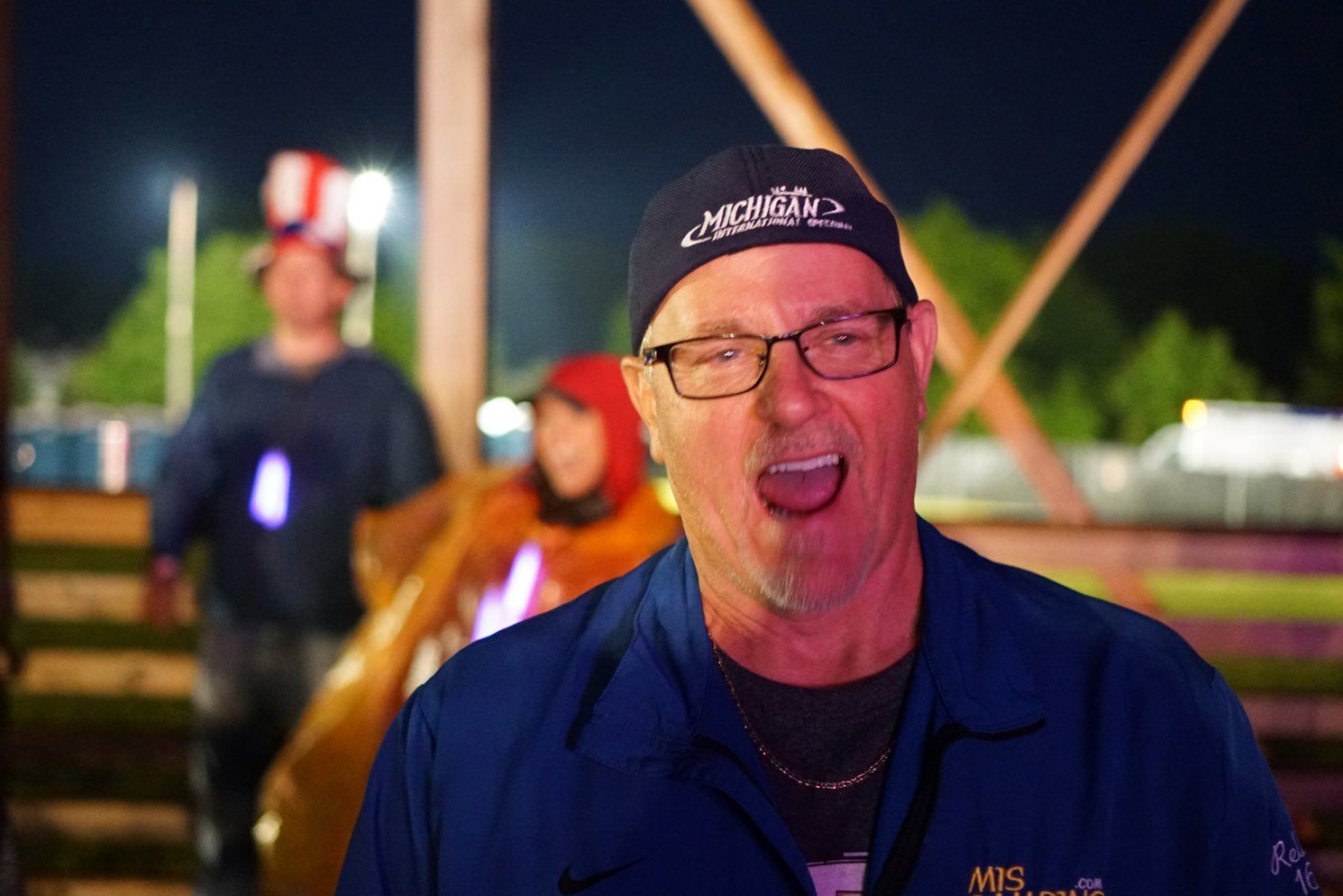 A man wearing glasses and a hat that says michigan on it
