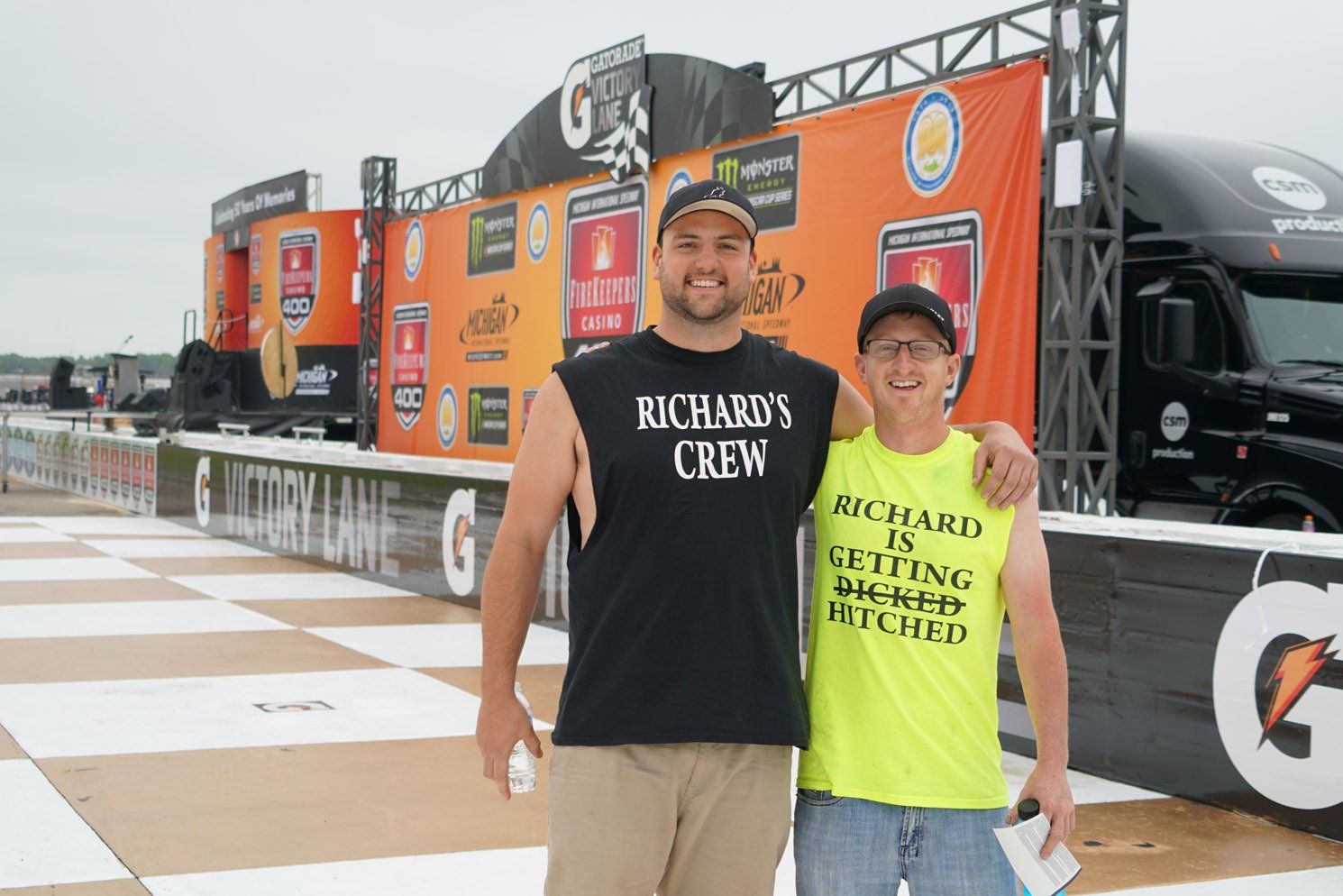 Two men posing for a picture with one wearing a shirt that says richard 's crew