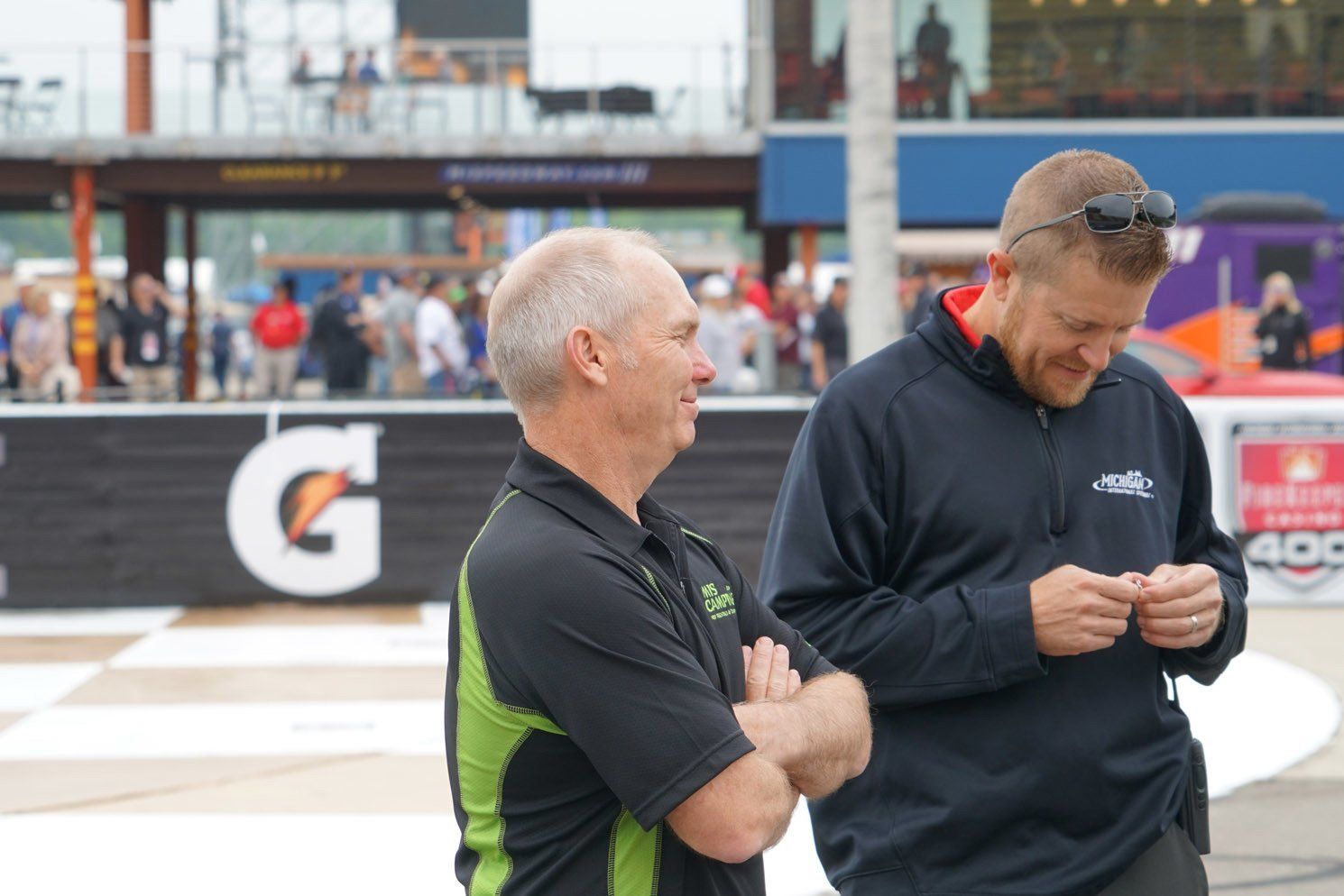 Two men standing in front of a gatorade sign