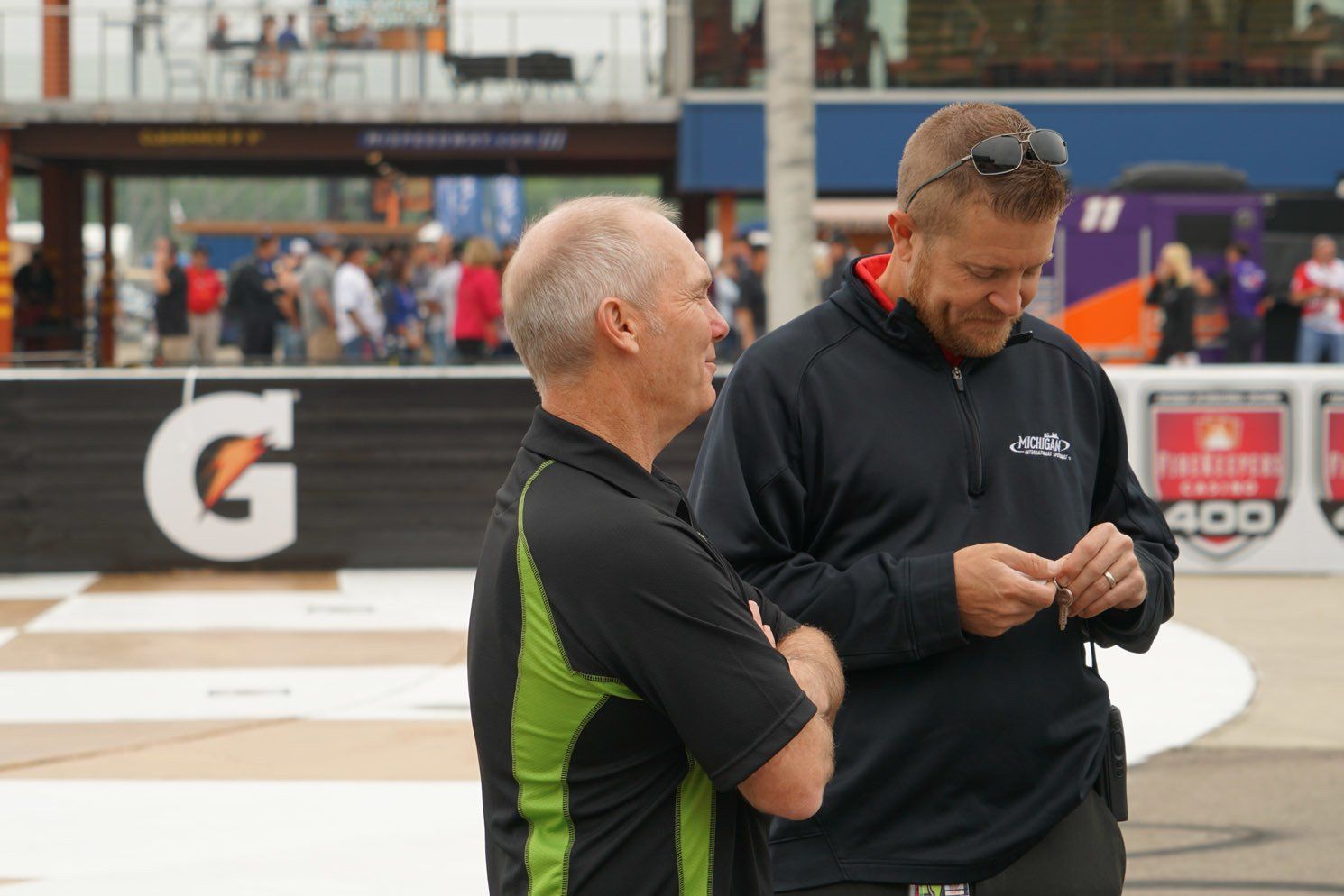 Two men standing in front of a gatorade sign