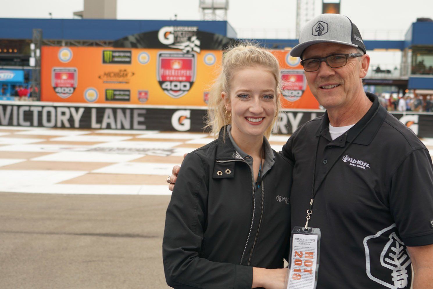 A man and a woman standing in front of a sign that says victory lane