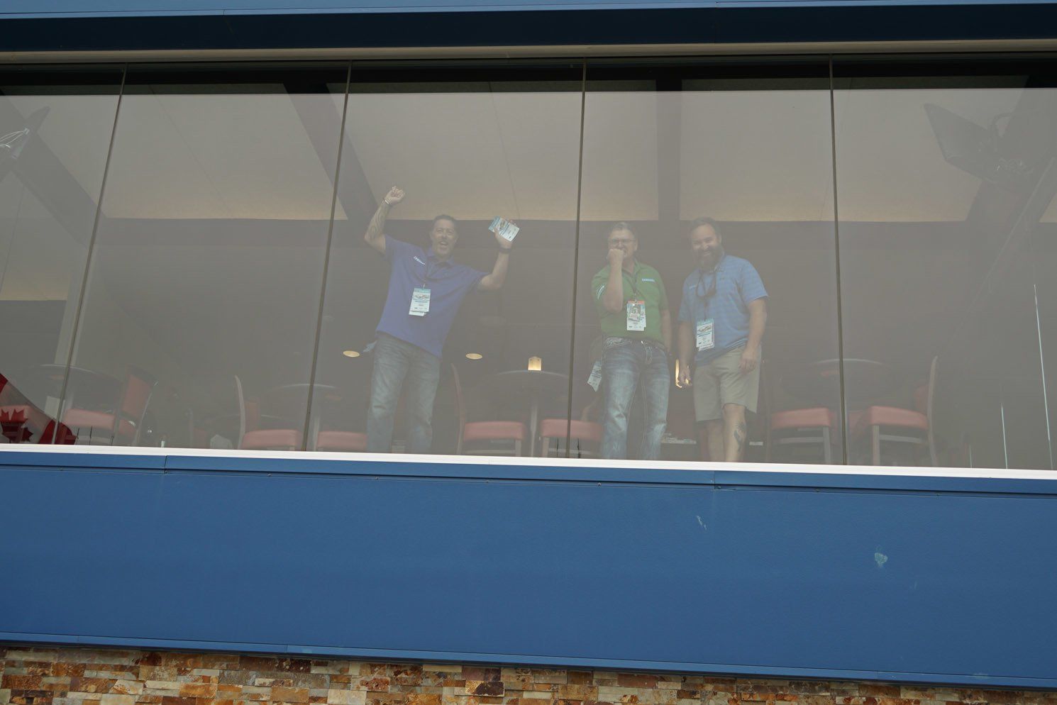 A group of people standing in front of a window