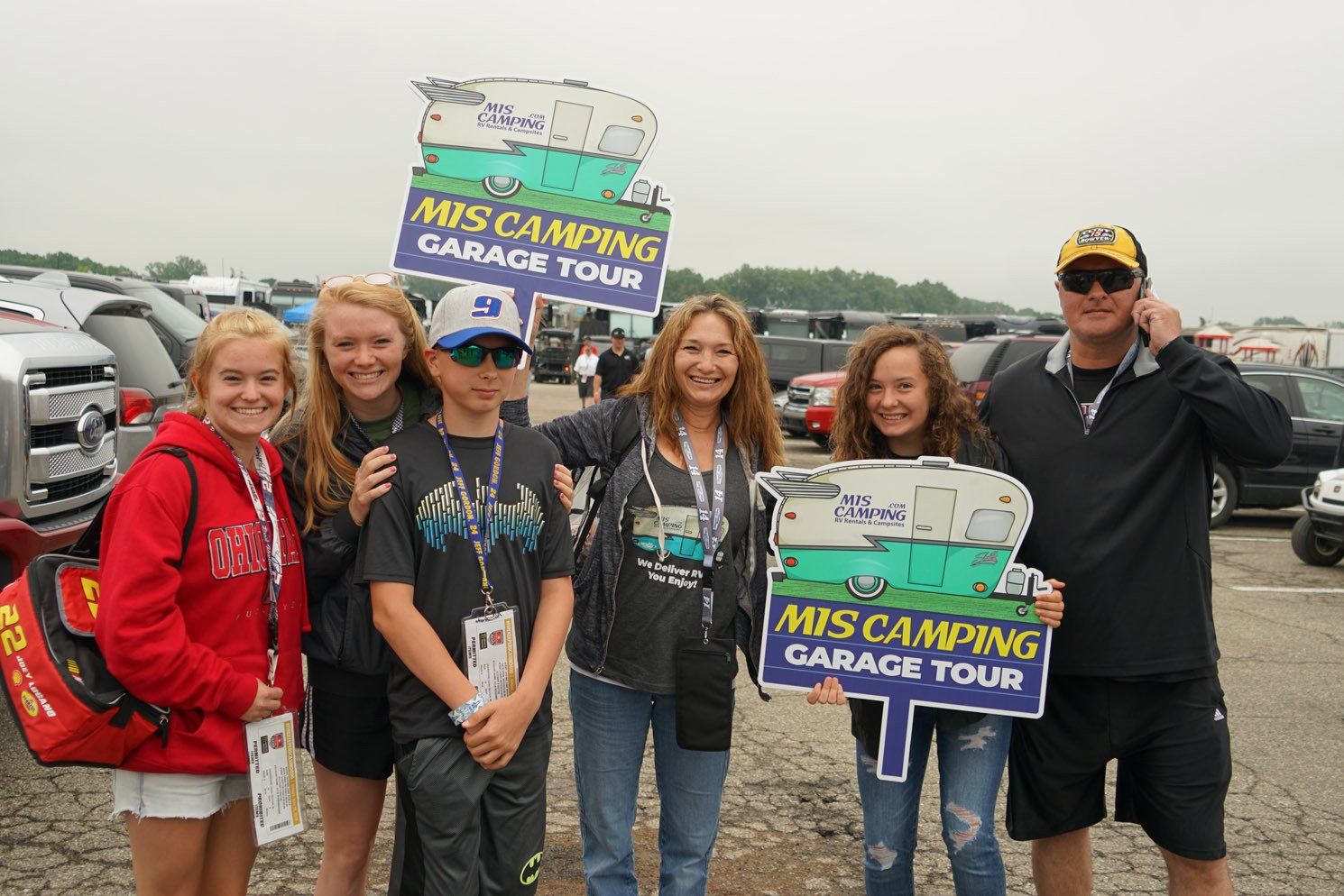 A group of people holding signs that say mrs camping garage tour