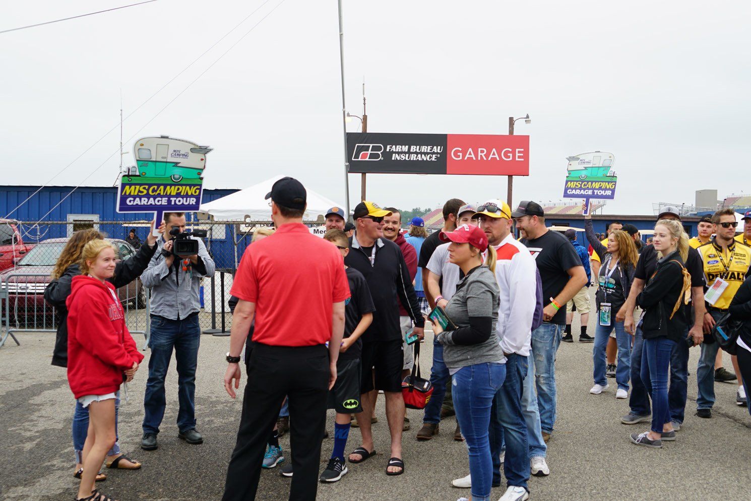 A group of people standing in front of a garage sign