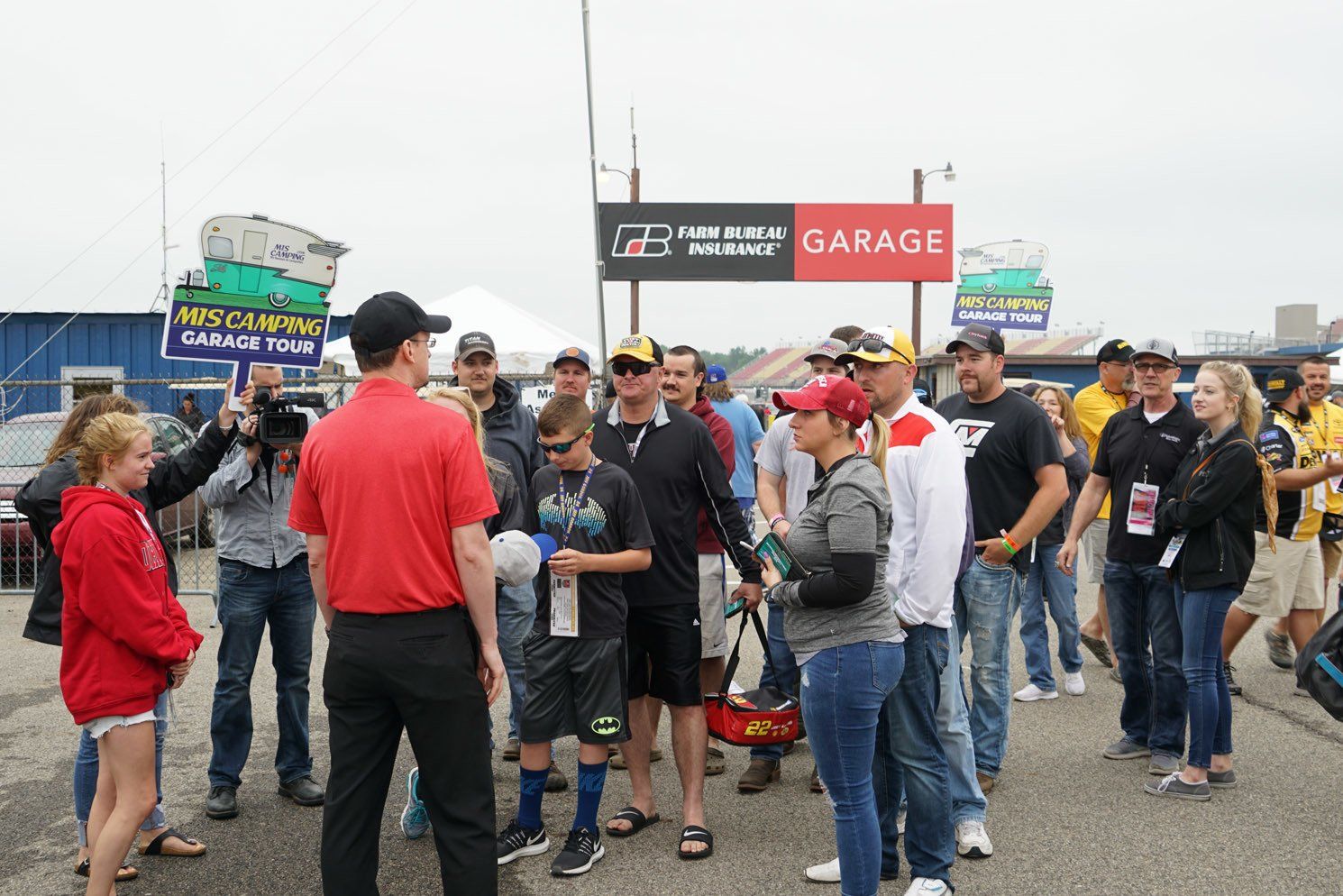 A group of people standing in front of a garage sign