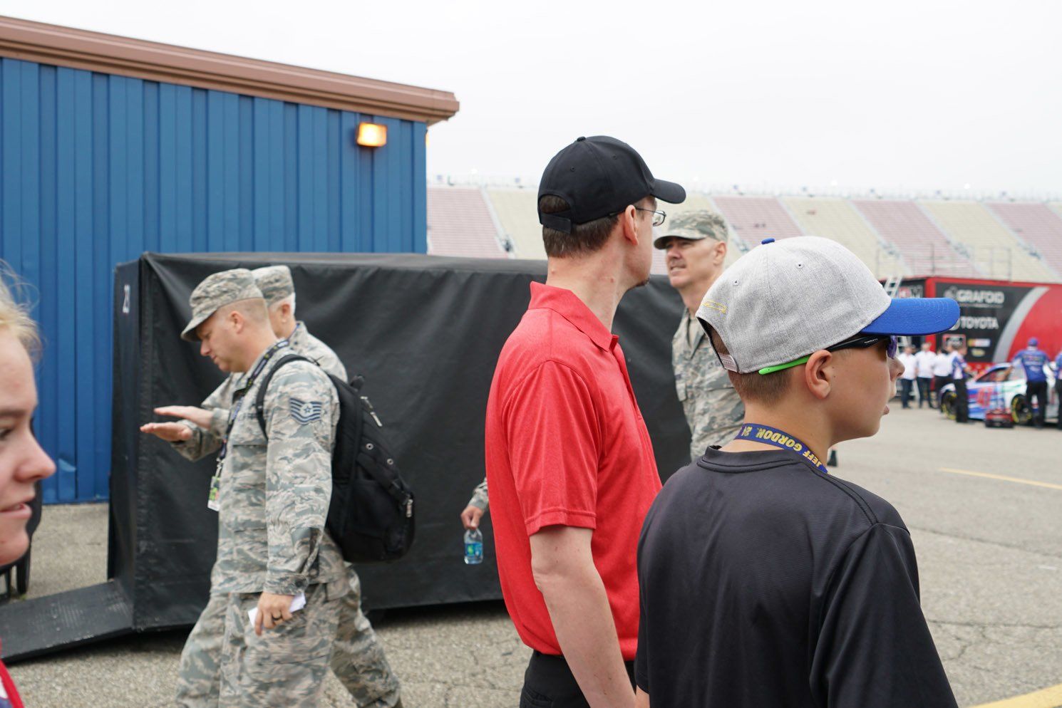 A group of people standing in front of a blue building