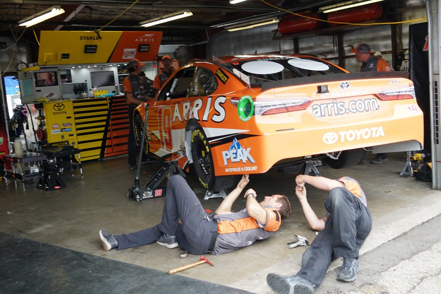 A toyota race car is being worked on in a garage
