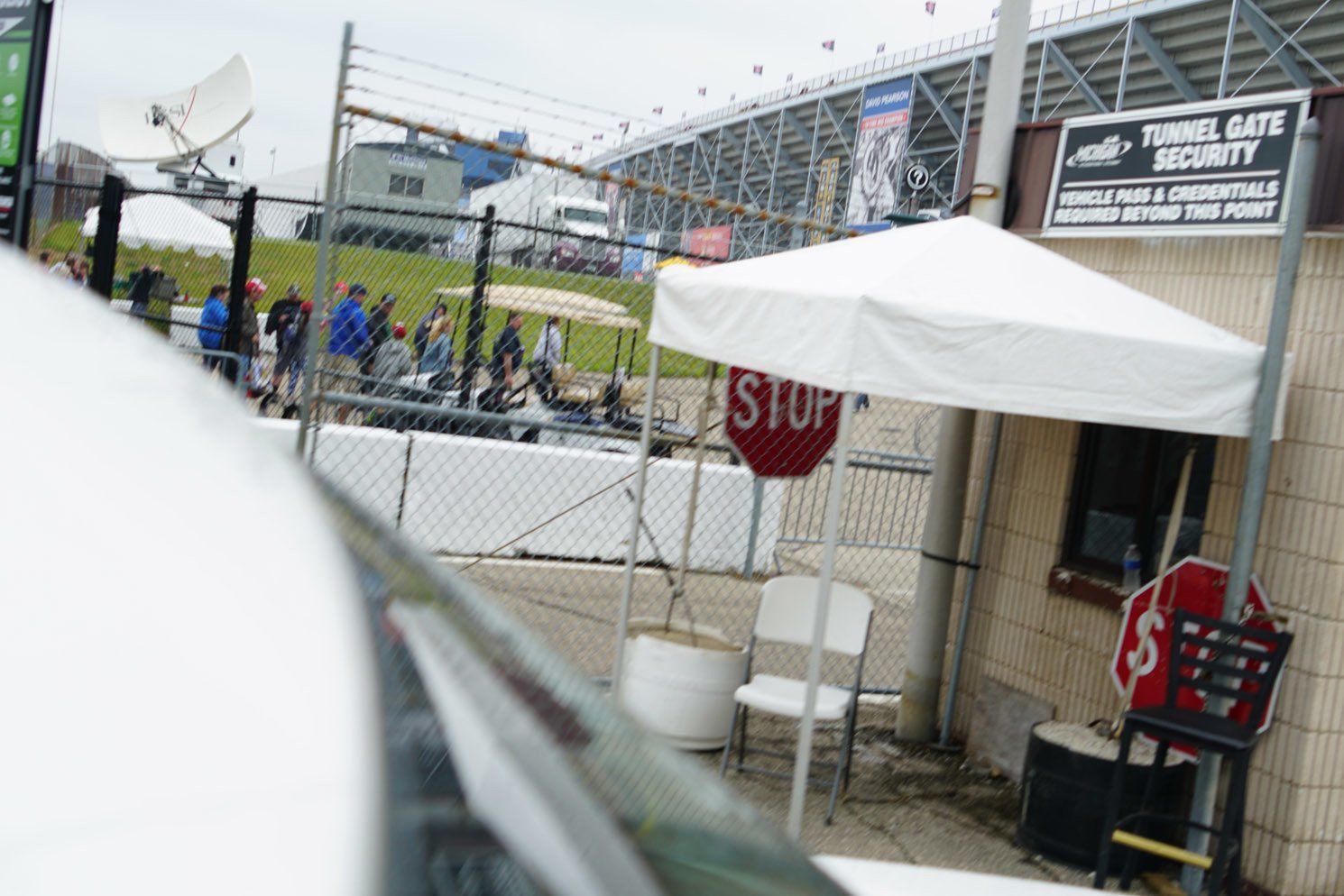 A stop sign is in front of a tunnel security booth