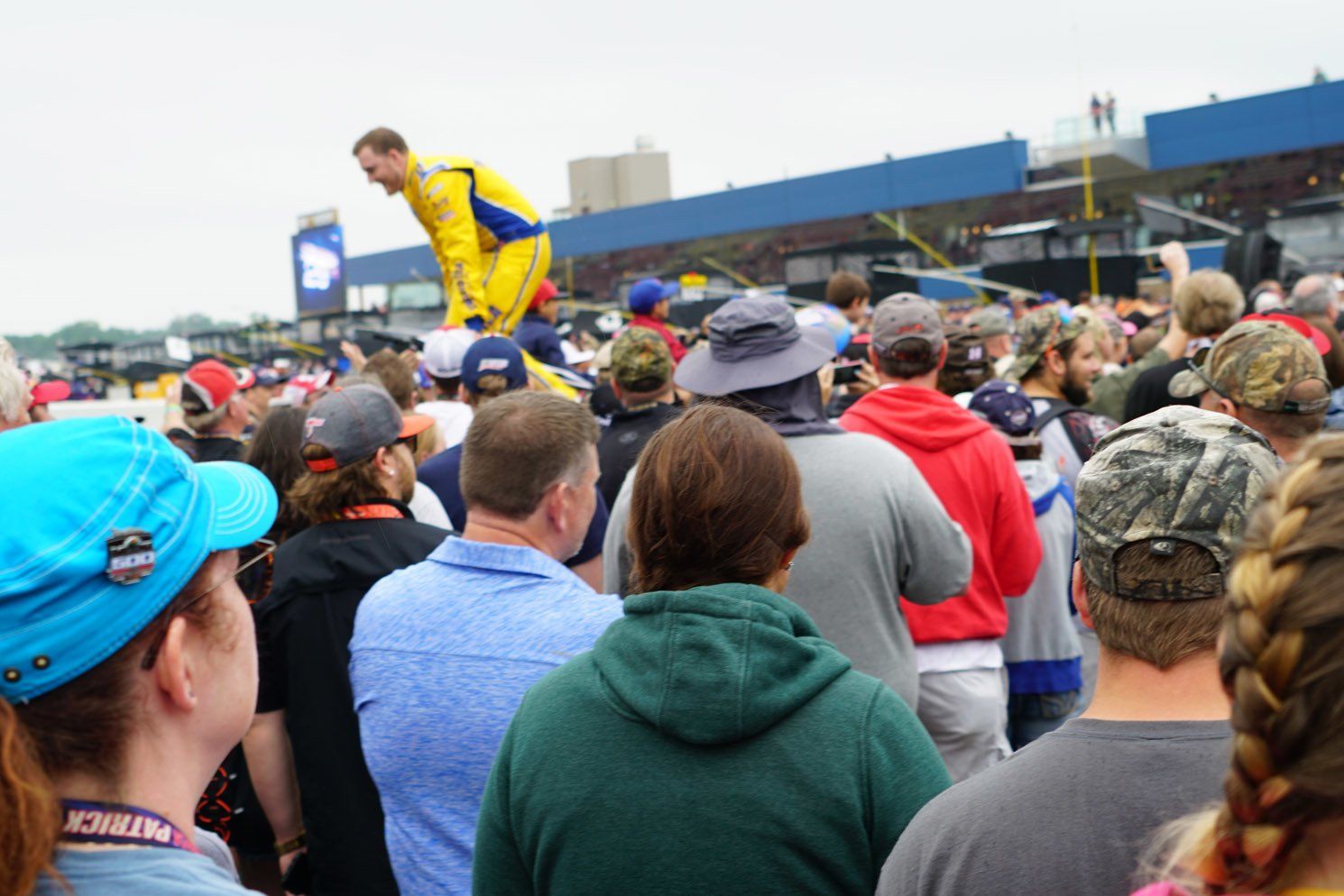A crowd of people watching a man on a podium