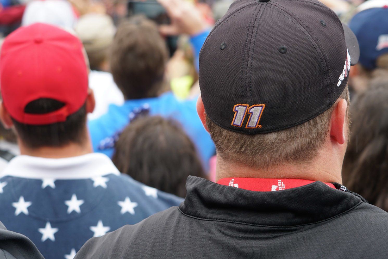 A man wearing a hat with the number 11 on it