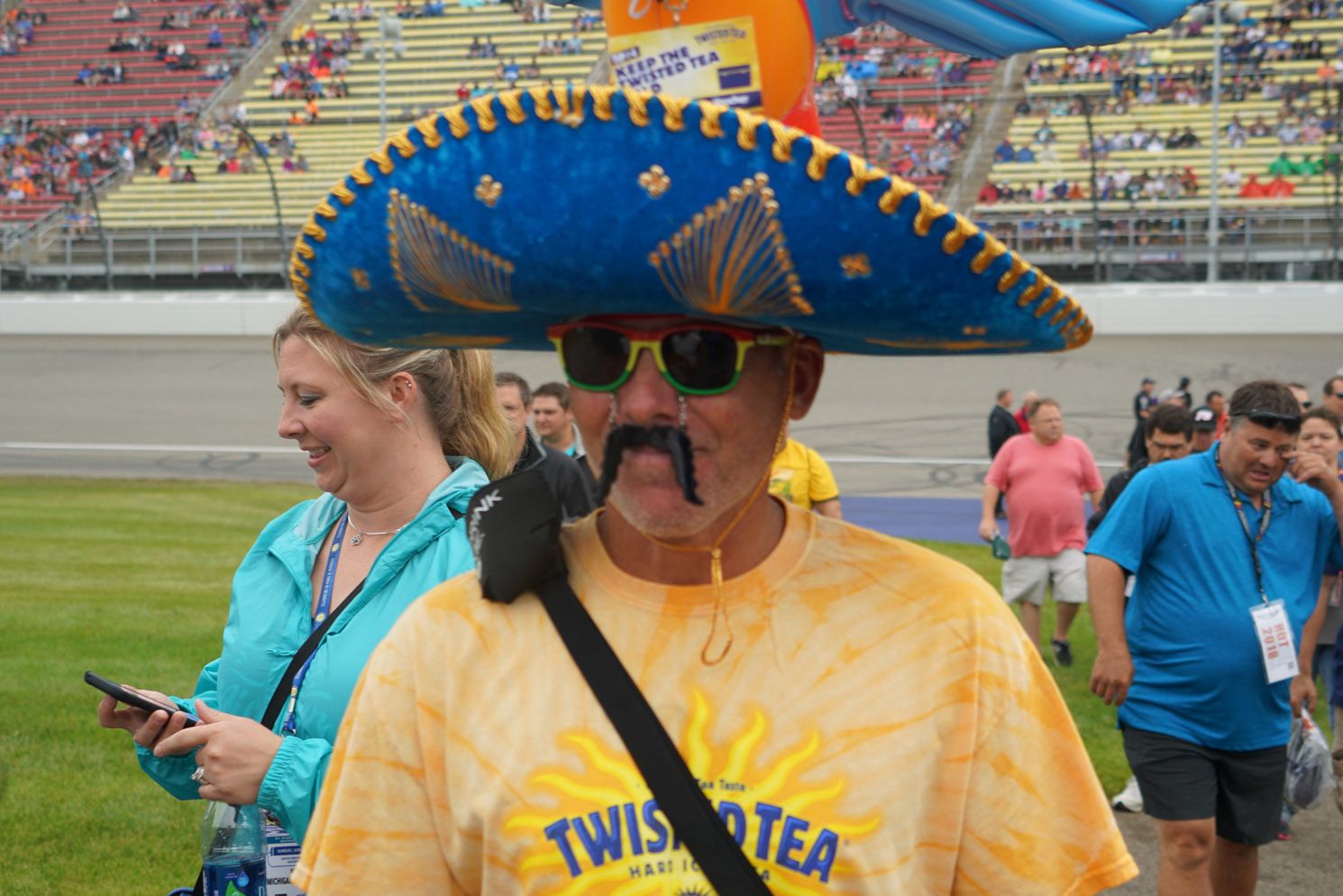 A man wearing a sombrero and a shirt that says twist tea
