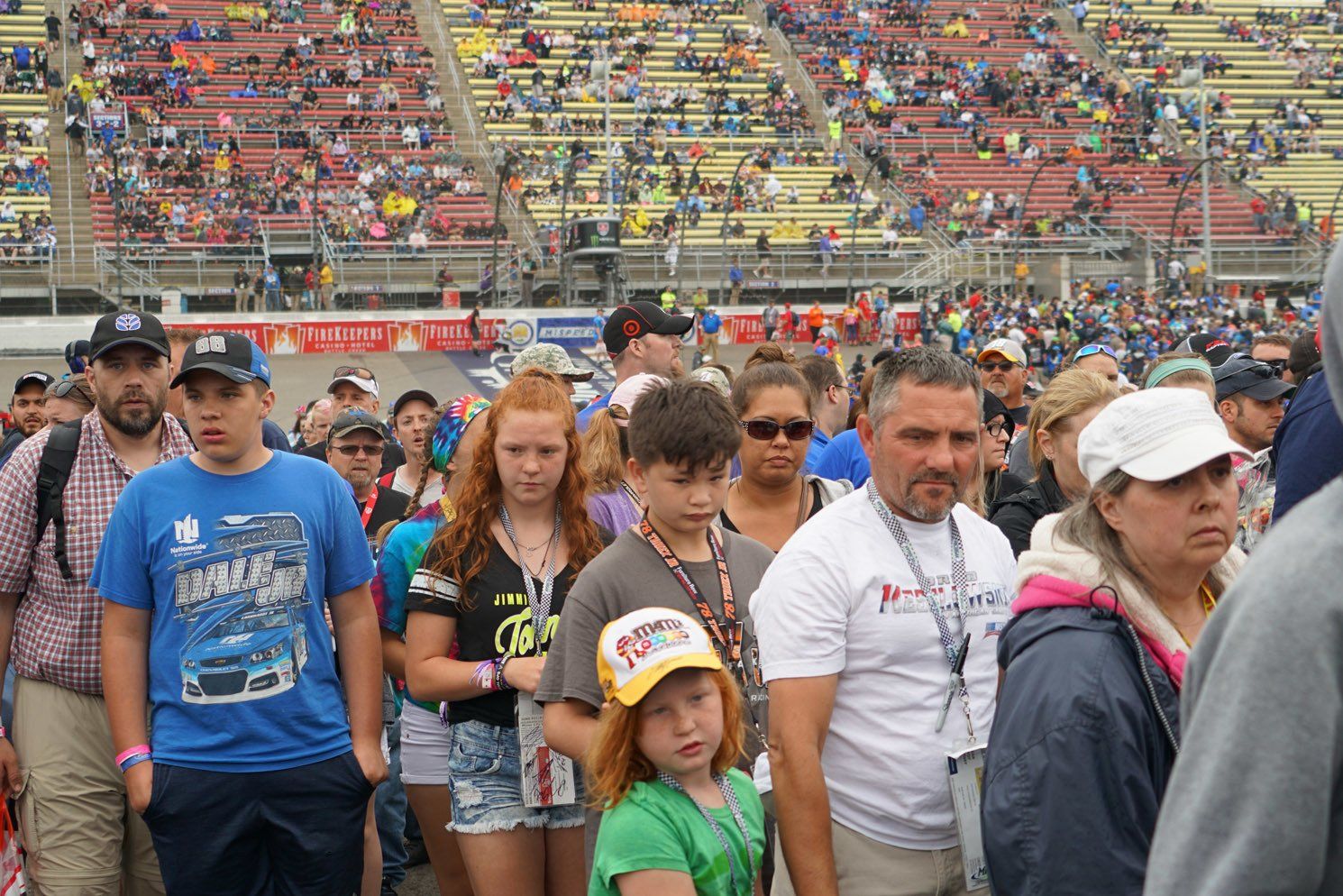 A crowd of people are walking through a stadium.