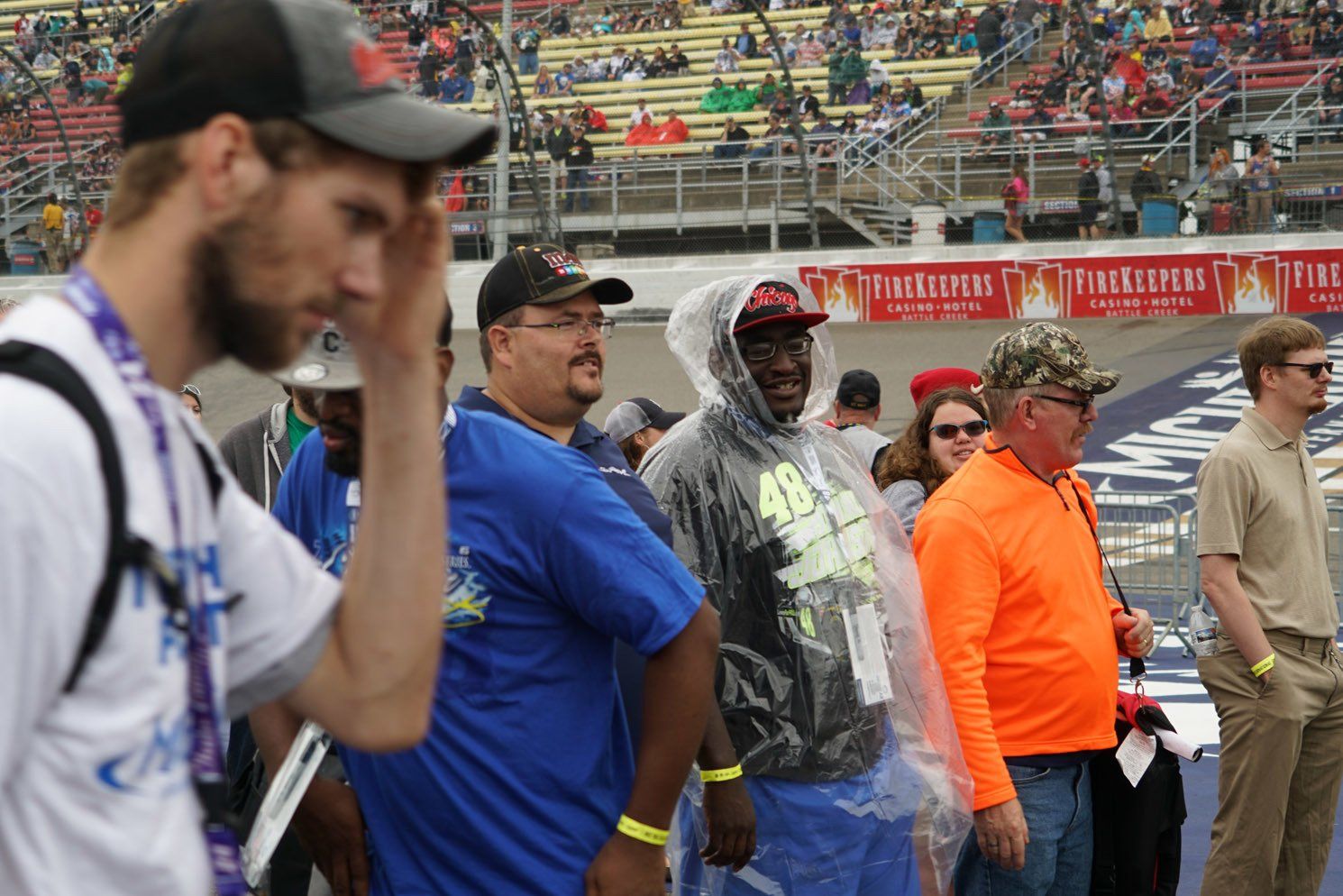 A group of people are standing in a stadium and one of them has the number 48 on his shirt