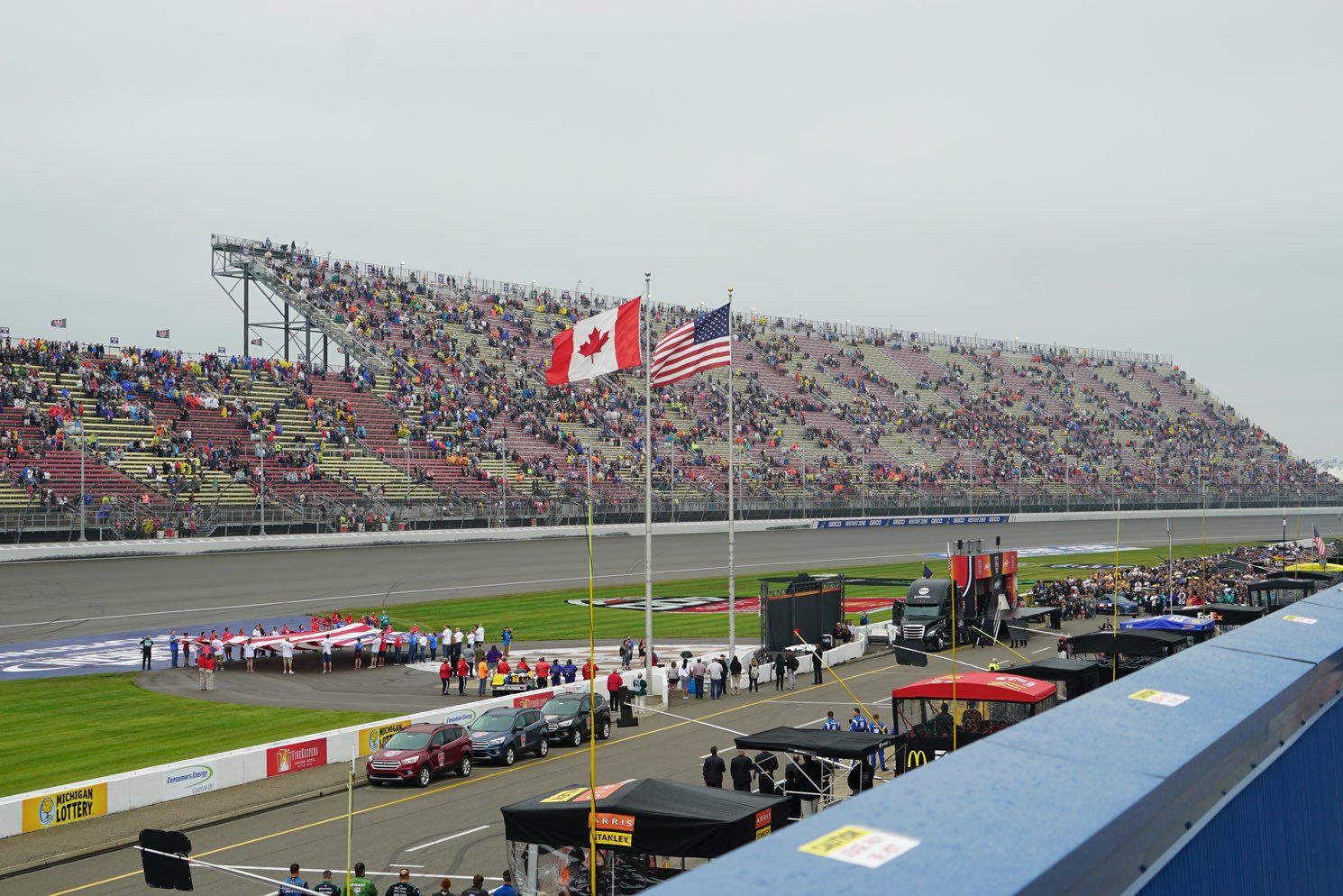 A race track with canadian and american flags flying