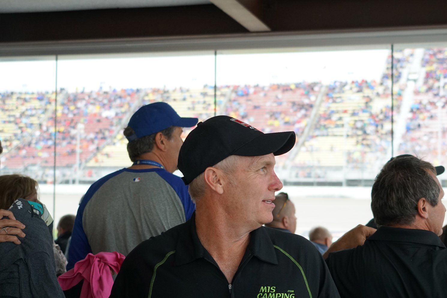 A man wearing a black shirt with the word camping on it
