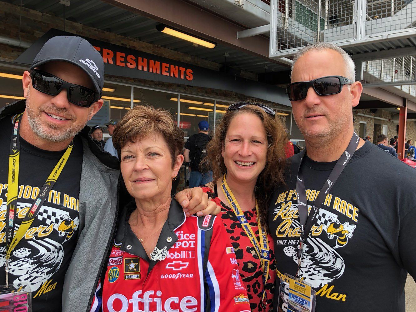 A group of people posing for a picture with one wearing a shirt that says office