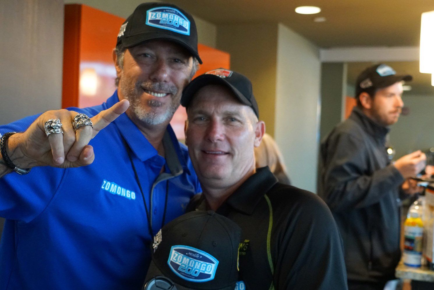 Two men posing for a picture with one wearing a shirt that says yamaha