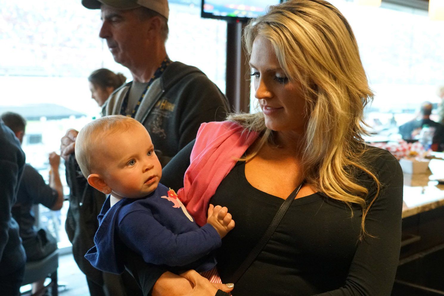 A woman is holding a baby in her arms