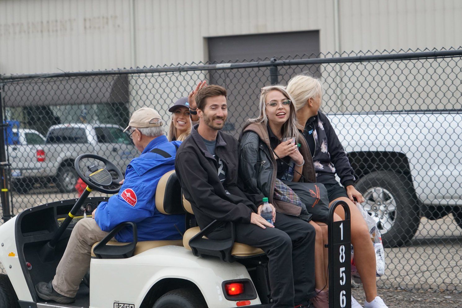 A group of people are sitting in a golf cart.