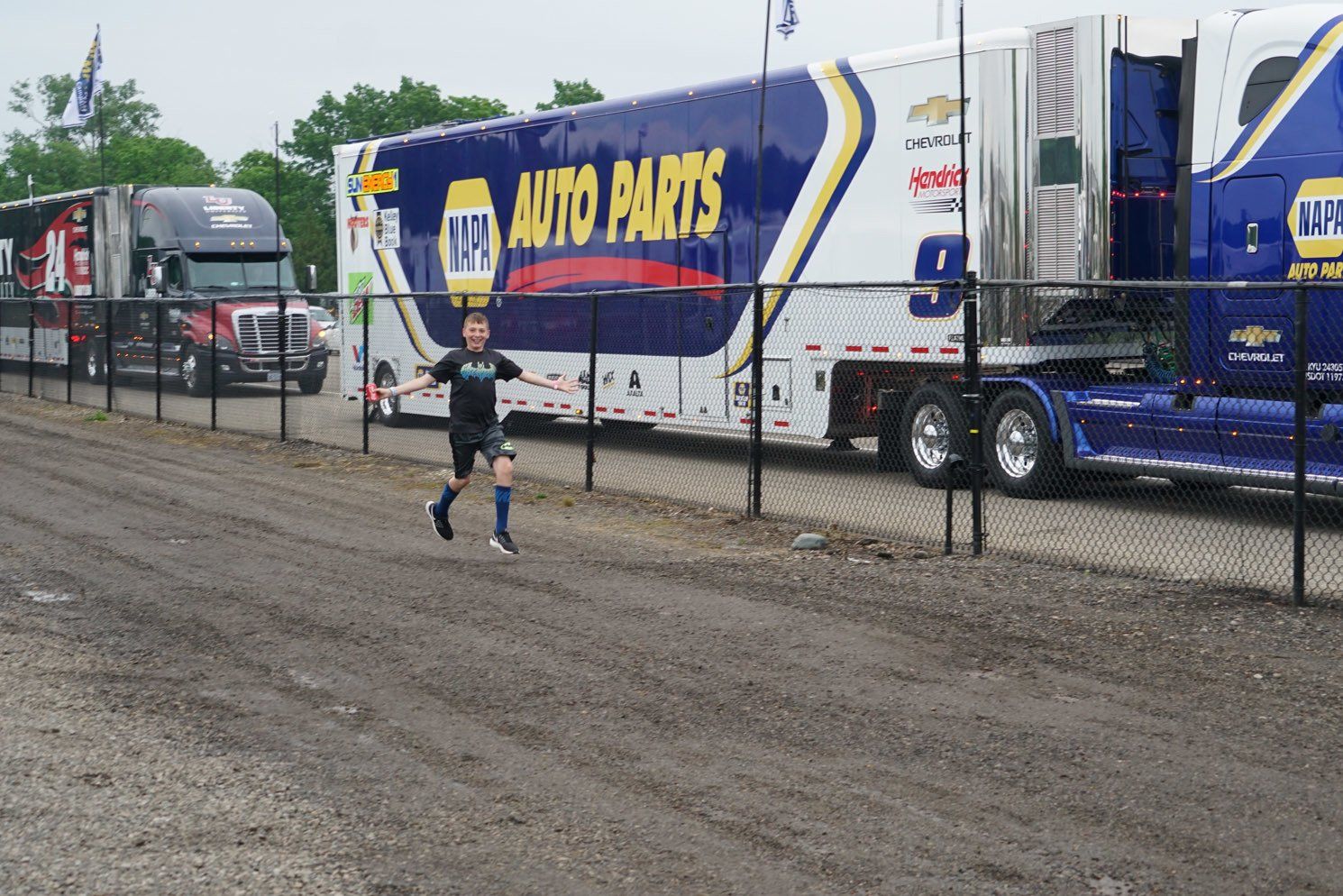 A man running in front of a truck that says auto parts