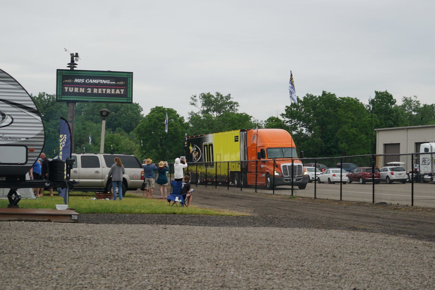 A group of people are standing in front of a sign that says rv retreat
