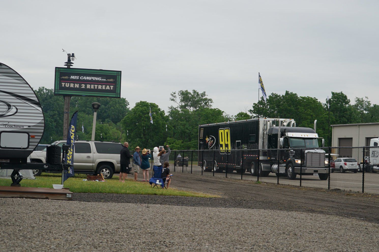 A group of people are standing in front of a trailer park.