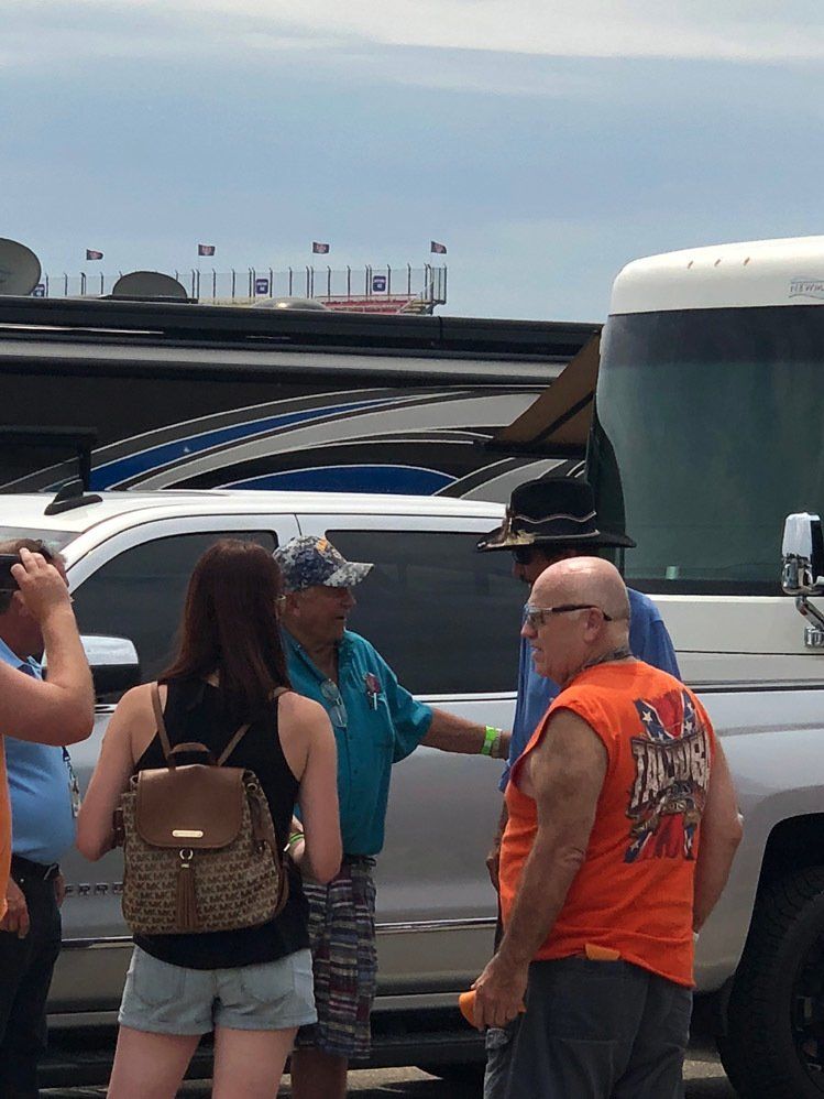 A group of people are standing in front of a truck