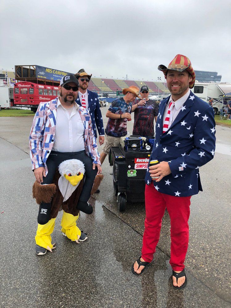 A group of men are standing next to each other wearing patriotic outfits.