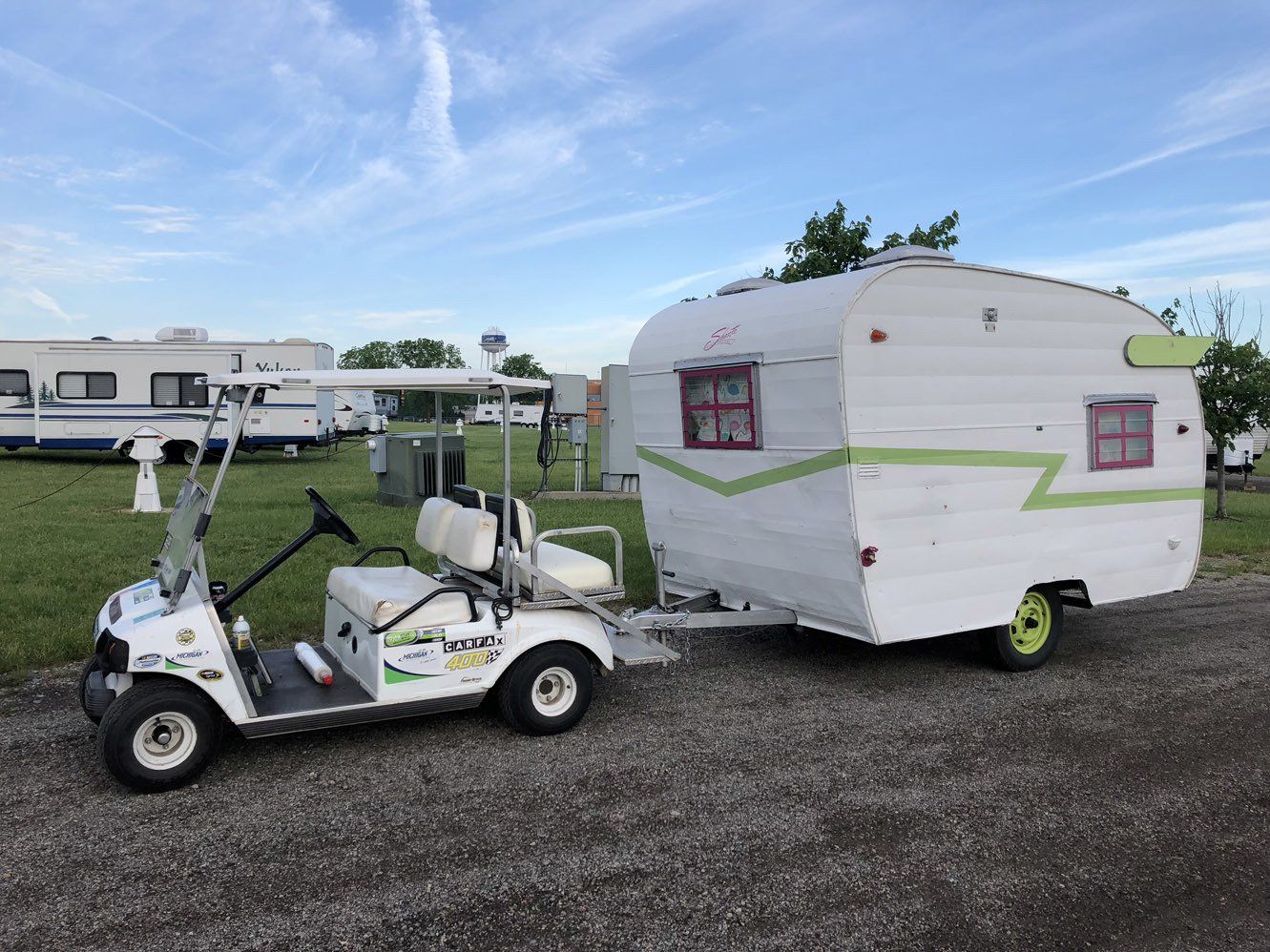 A golf cart with a trailer attached to it