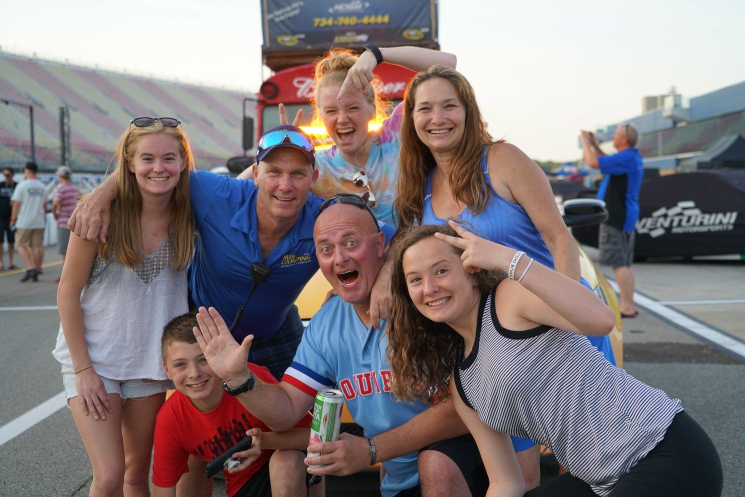 A group of people posing for a picture in front of a bus