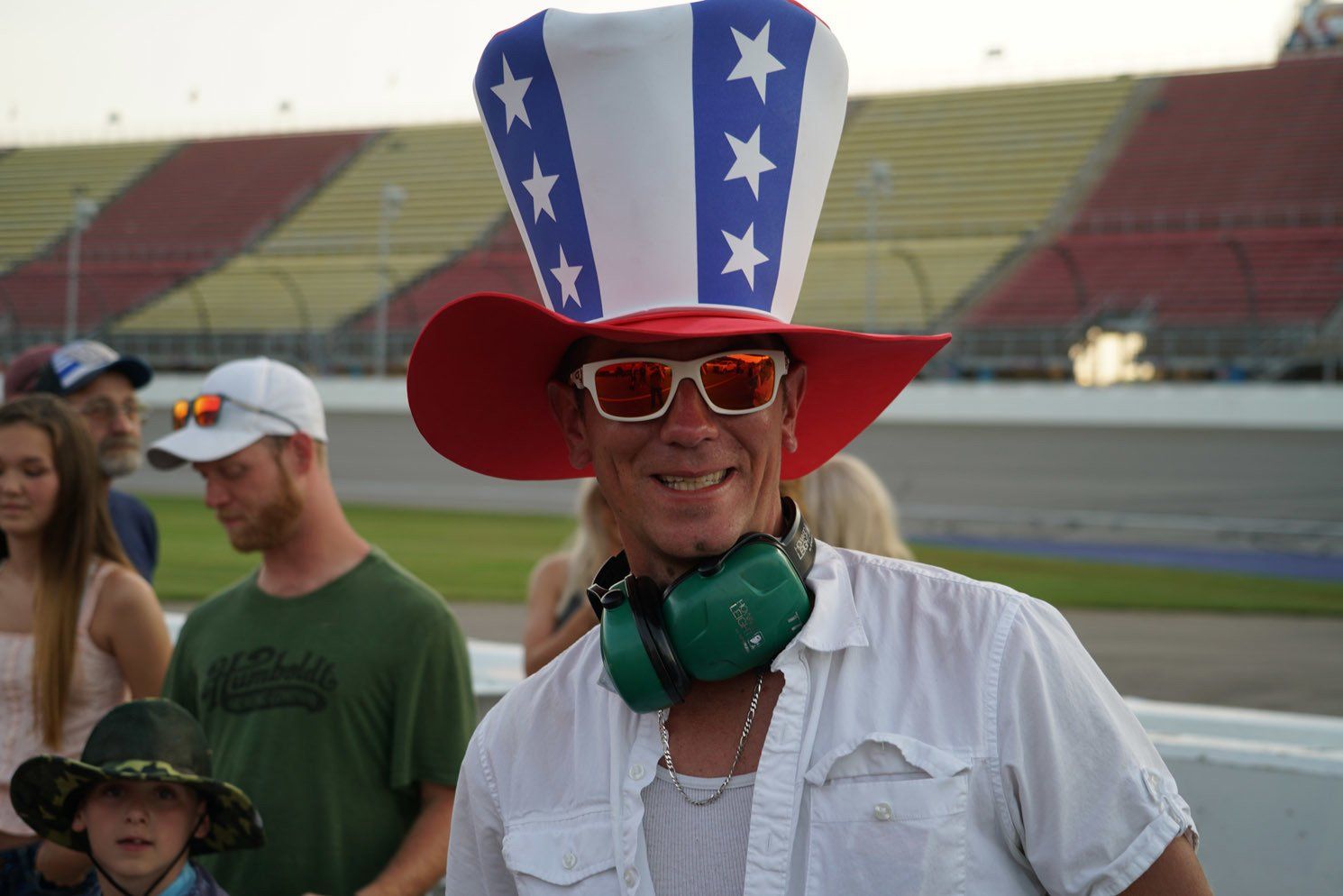A man wearing a red white and blue hat and sunglasses