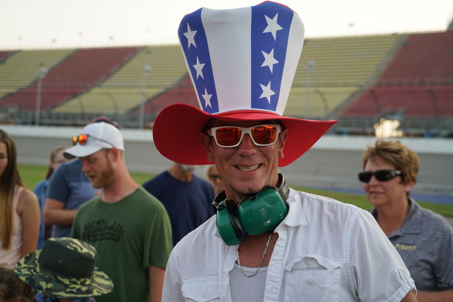 A man wearing a red white and blue hat and sunglasses