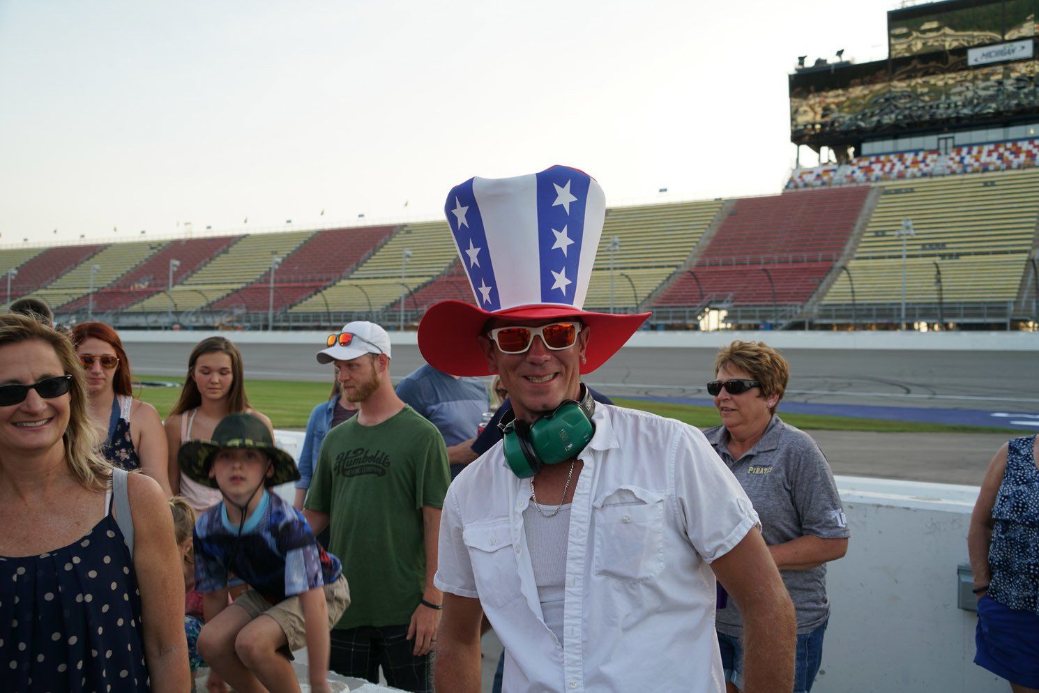 A man wearing a red white and blue hat and sunglasses