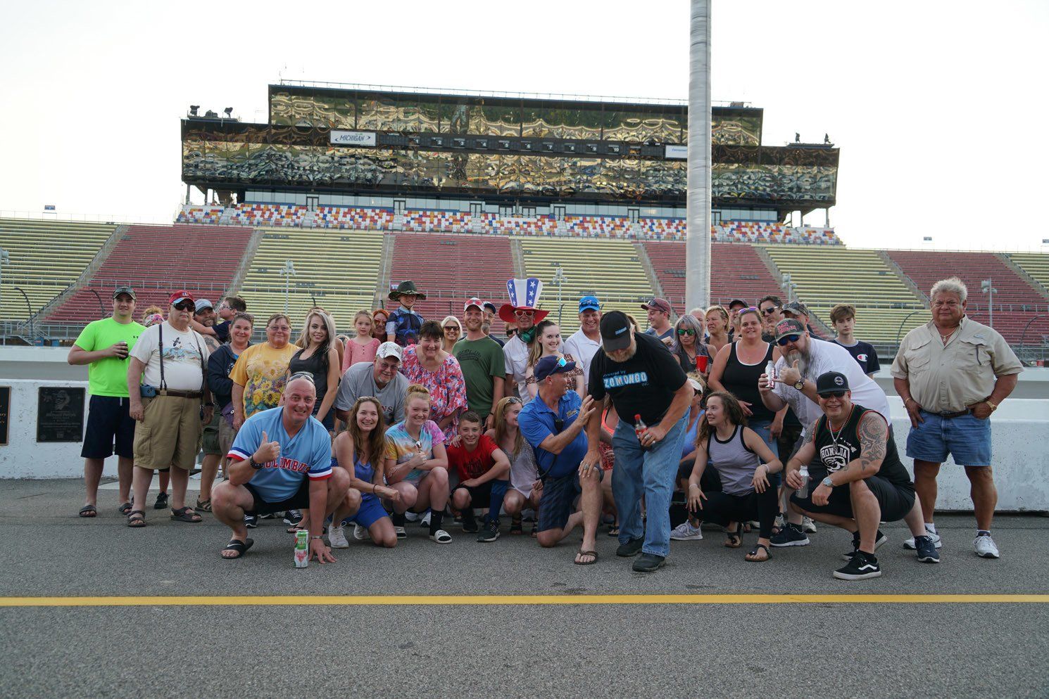 A group of people are posing for a picture in front of a stadium.