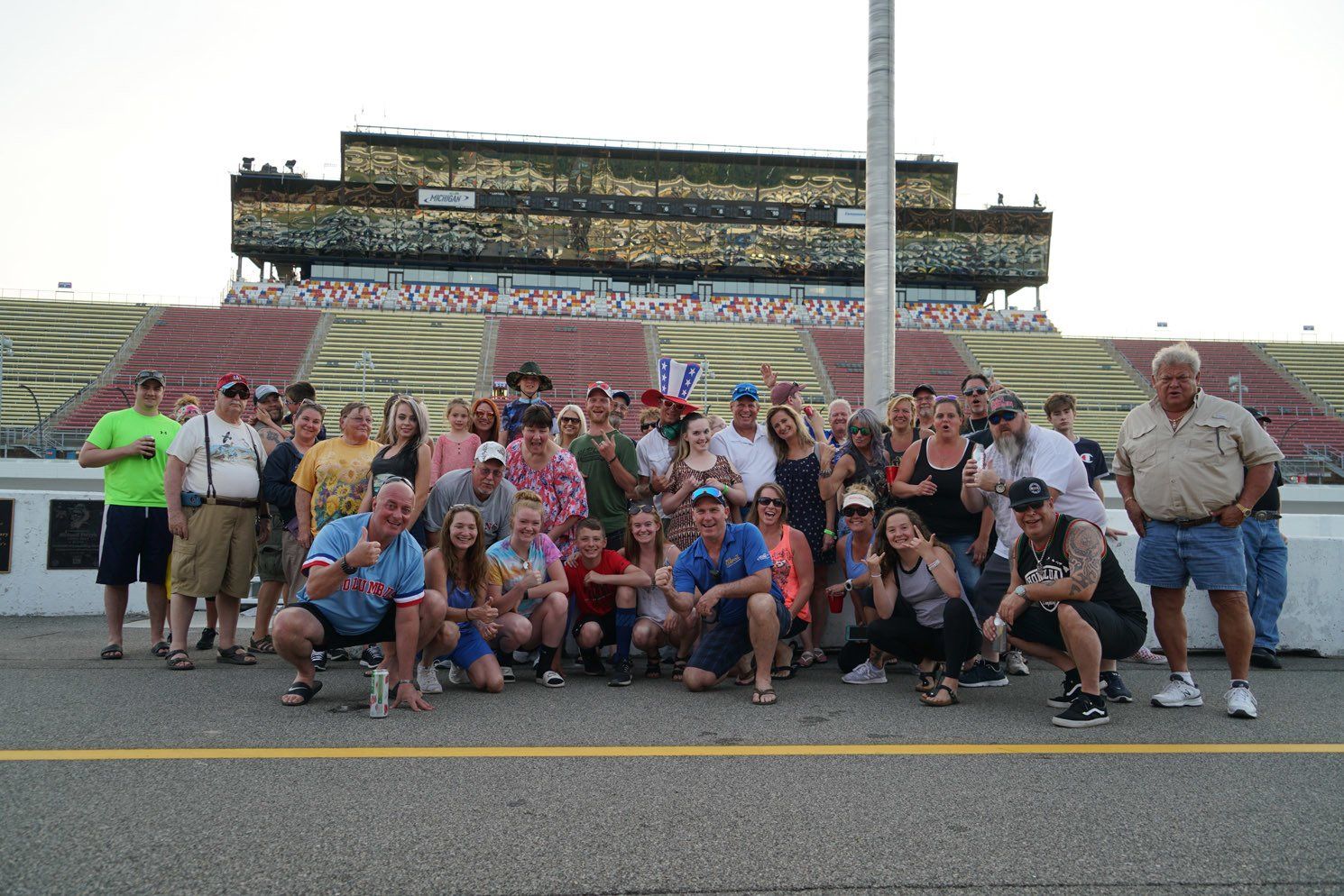 A group of people are posing for a picture in front of a stadium.