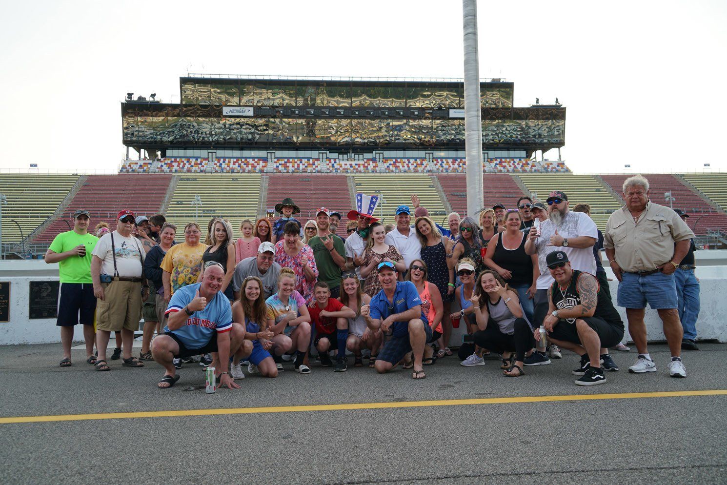 A group of people are posing for a picture in front of a stadium.
