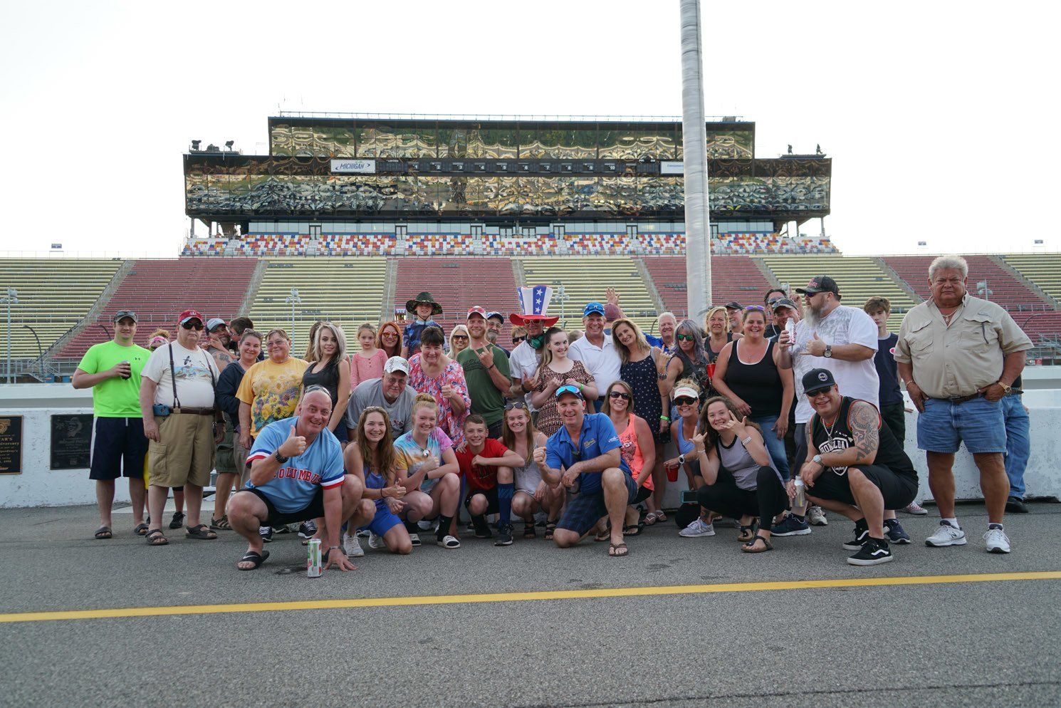 A group of people are posing for a picture in front of a stadium.