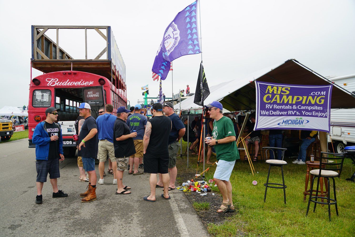 A group of people standing in front of a sign that says mrs camping
