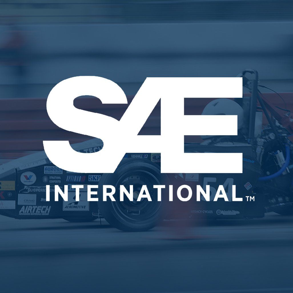 A logo for sae international with a race car in the background