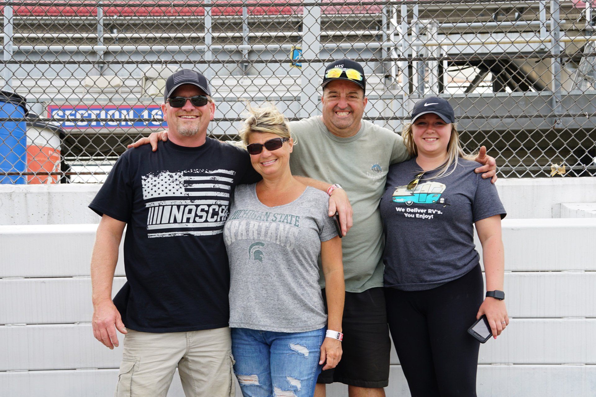 A group of people posing for a picture with one of them wearing a shirt that says minnesota
