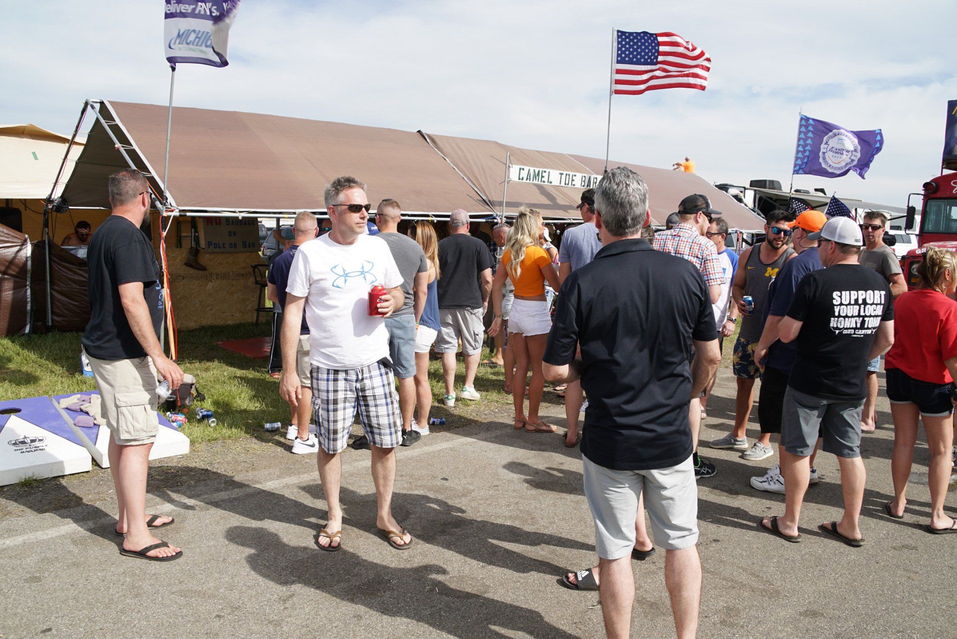 A group of people standing in front of a building with flags