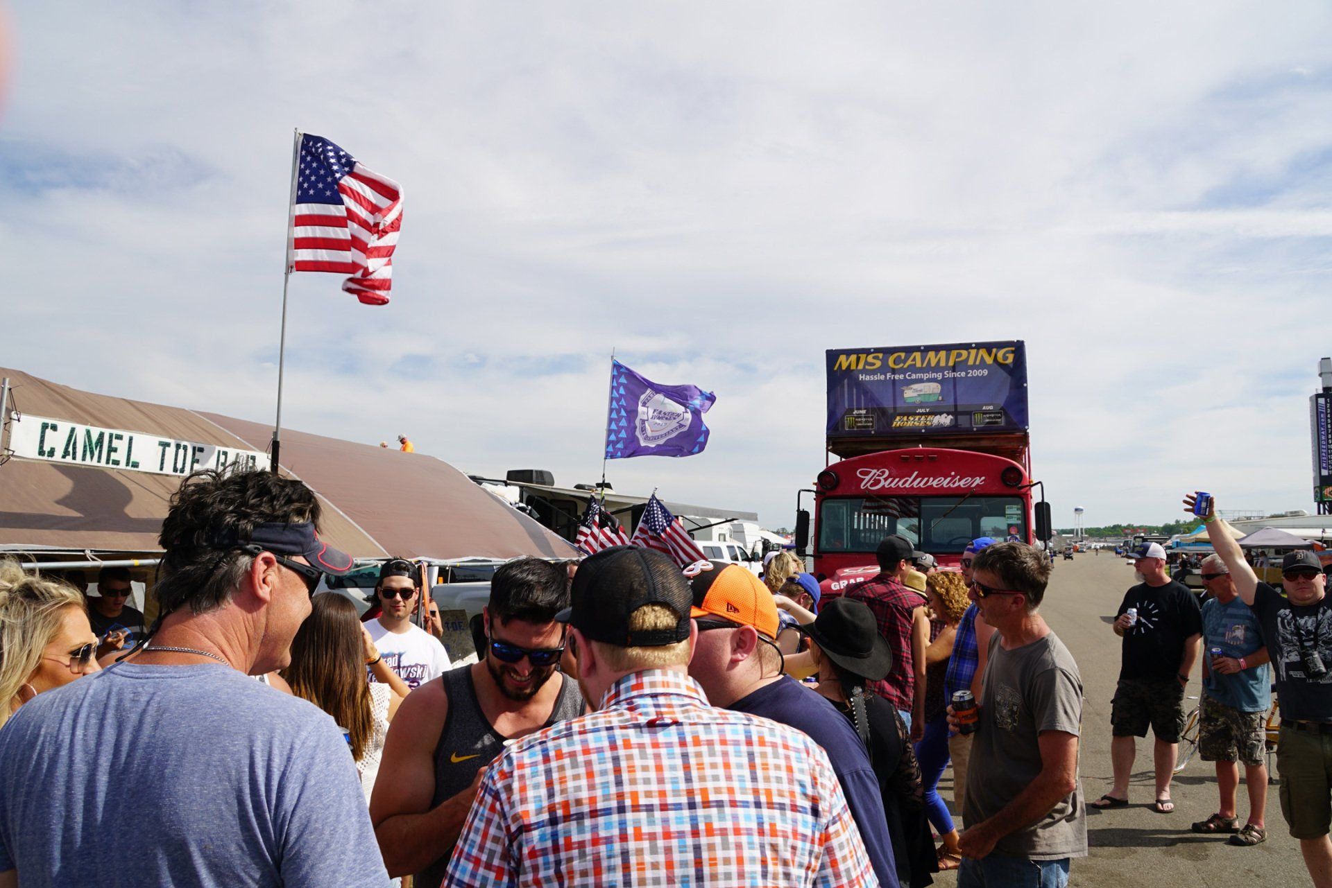 A group of people are standing in front of a building that says camel palace
