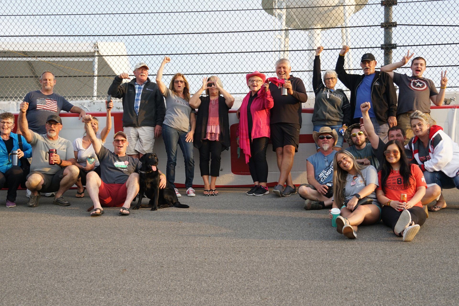 A group of people posing for a picture with their hands in the air