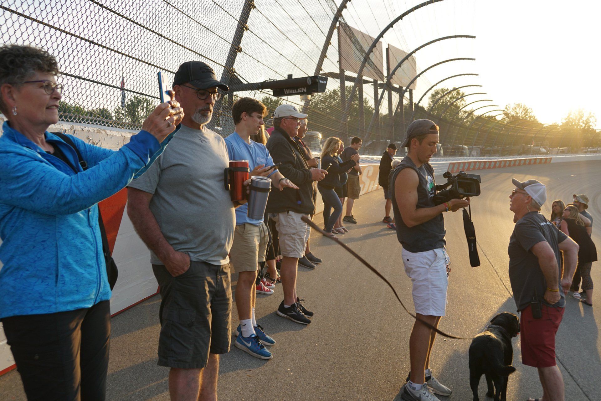 A woman is taking a picture of a man with a camera