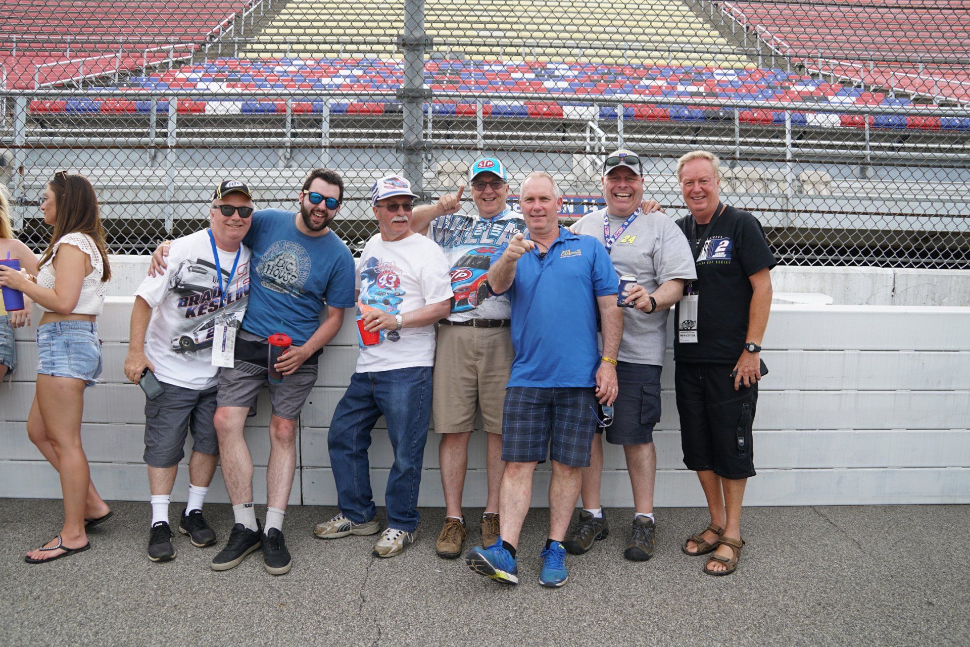 A group of people posing for a picture in front of a stadium