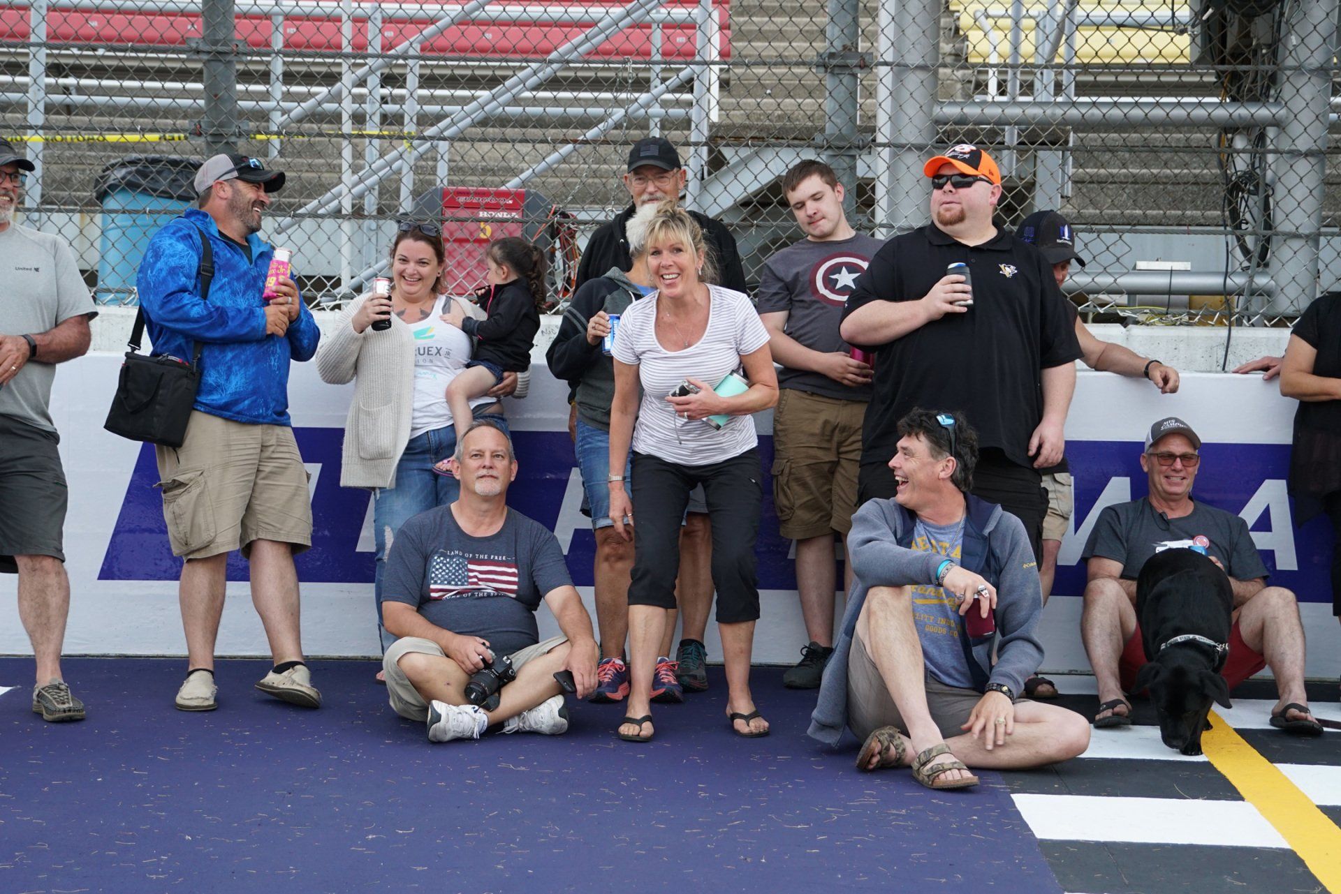 A group of people are posing for a picture in front of a sign that says a on it